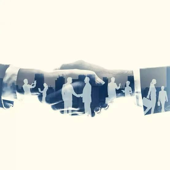 Hands shaking with cityscape overlay